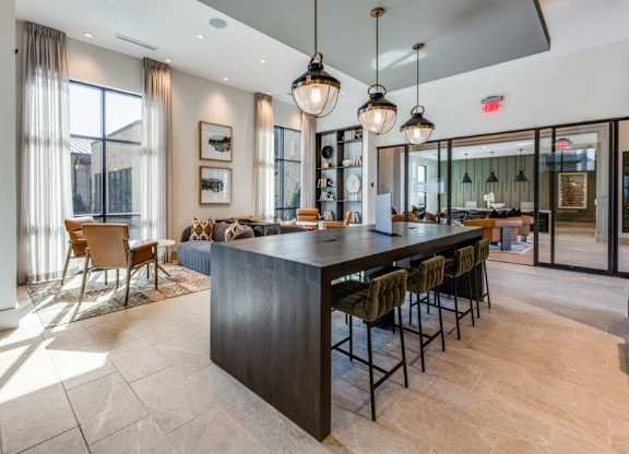 A modern kitchen with a bar area and a dining table.