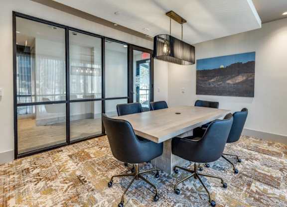 A conference room with a table and chairs.