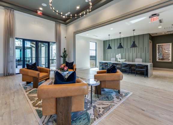 A large room with a couch, chairs, and a table.