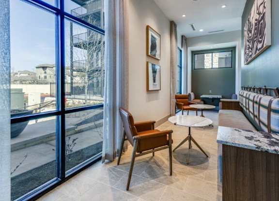 A modern living room with a view of the outside through large windows.