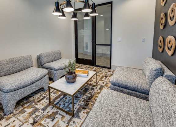 A living room with grey couches and a coffee table.