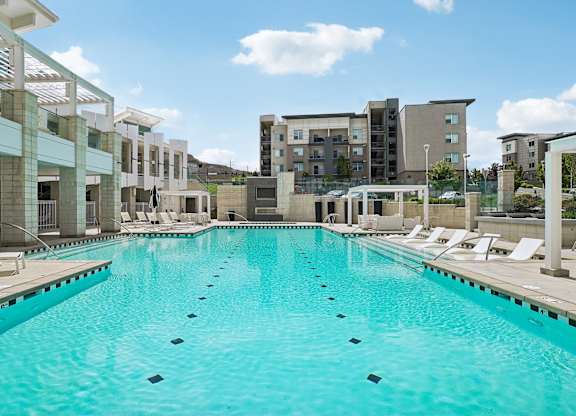 A large swimming pool in front of a building.