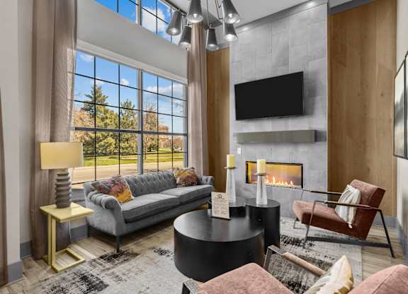 a living room with couches and a fireplace and a large window at Alton Jefferson Park, Denver, CO 80211