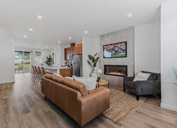 A modern living room with a fireplace and a painting on the wall.