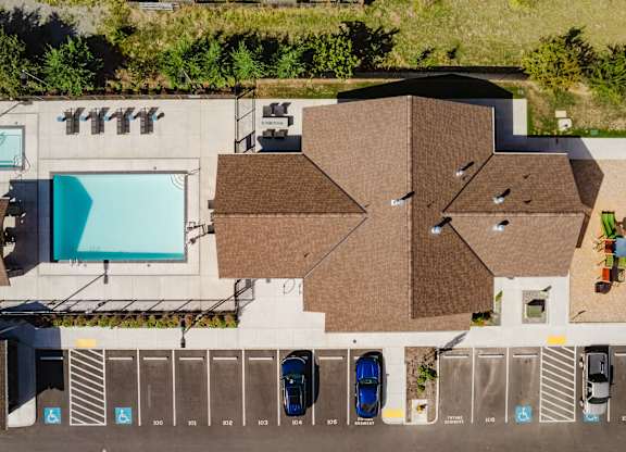 An aerial view of a parking lot with cars parked in designated spots.