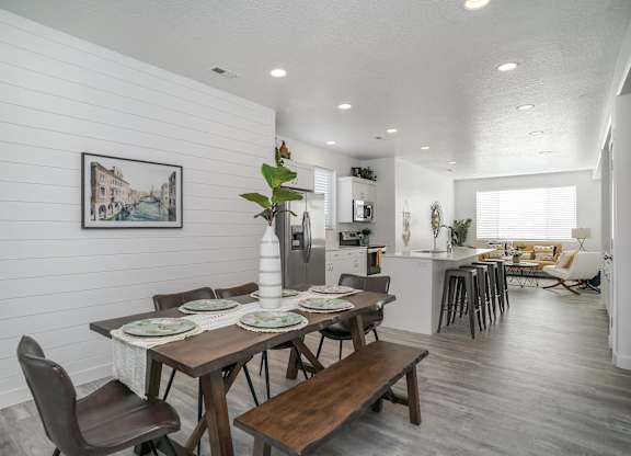 a dining room with a table and chairs and a kitchen