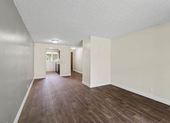 A room with wooden floors and white walls.
