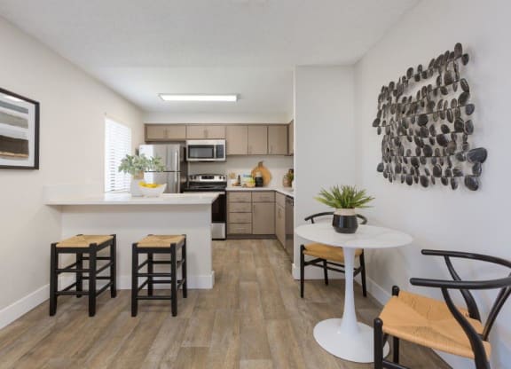 an open kitchen and living room with a table and chairs