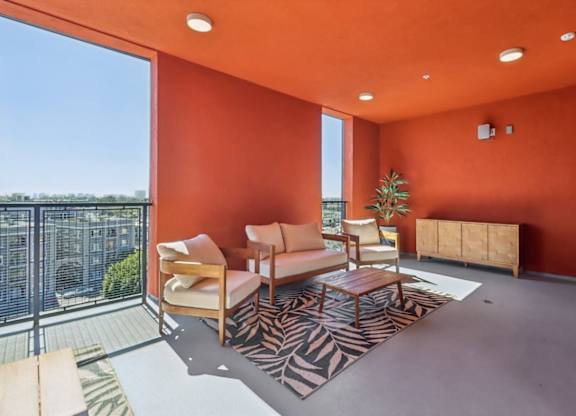 A living room with orange walls and furniture.
