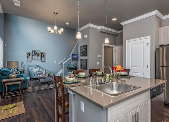 A modern kitchen with a dining area and a living room.