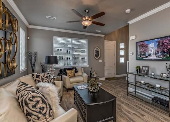 A living room with a white couch and a black coffee table.