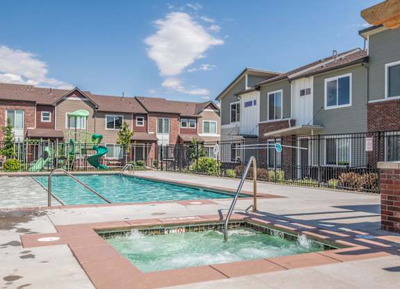 A small pool with a slide in a residential area.