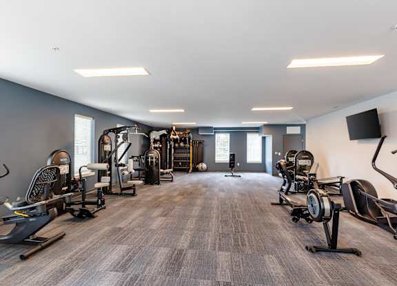 A spacious gym with a variety of equipment.