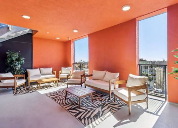 A living room with orange walls and furniture.