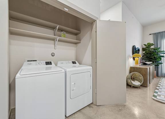 A laundry room with a washer and dryer in it.
