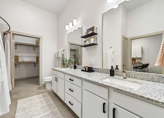 A bathroom with a white towel hanging on a rack.
