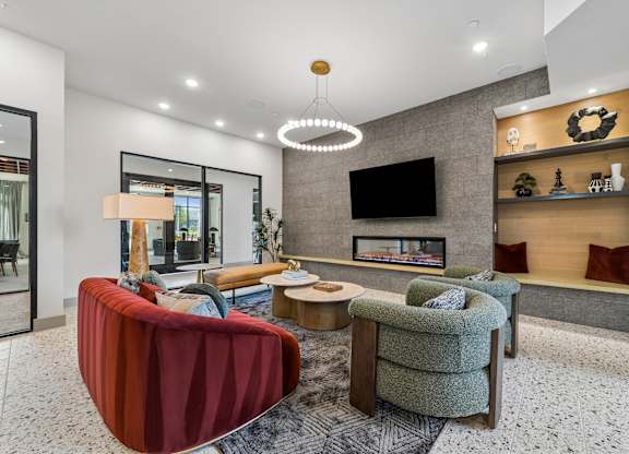 A modern living room with a red sofa and a fireplace.
