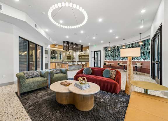 A modern living room with a red couch and a coffee table.