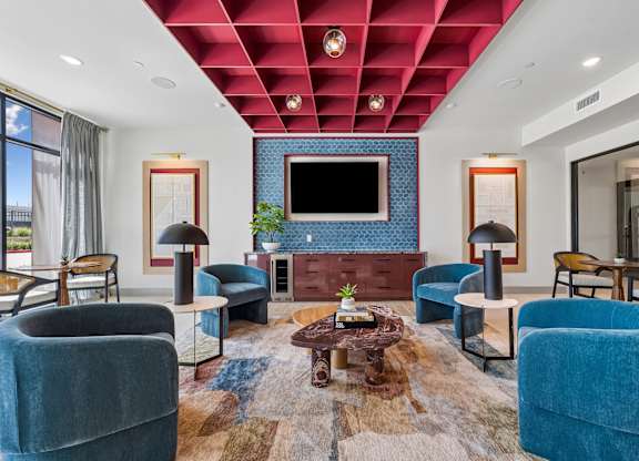 A living room with a blue couch and a television.