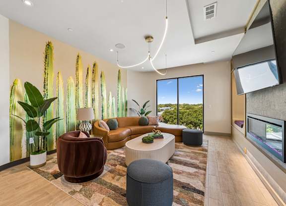 A living room with a couch, a chair, a table, and a television.