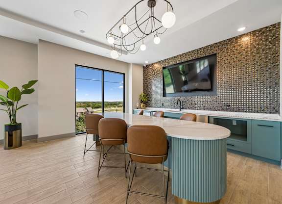 A modern kitchen with a dining table and chairs.