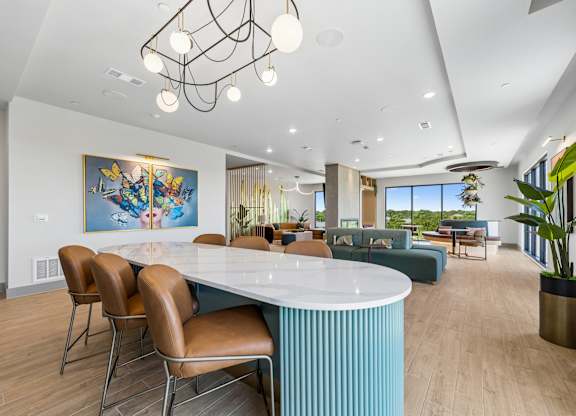 A modern dining room with a large table and chairs.