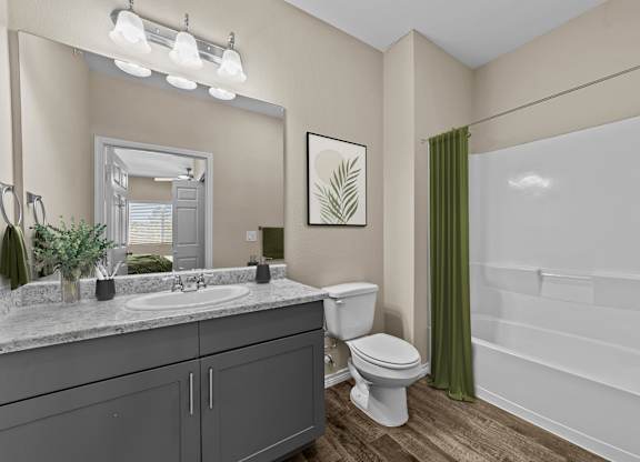 A bathroom with a toilet, sink, and bathtub.