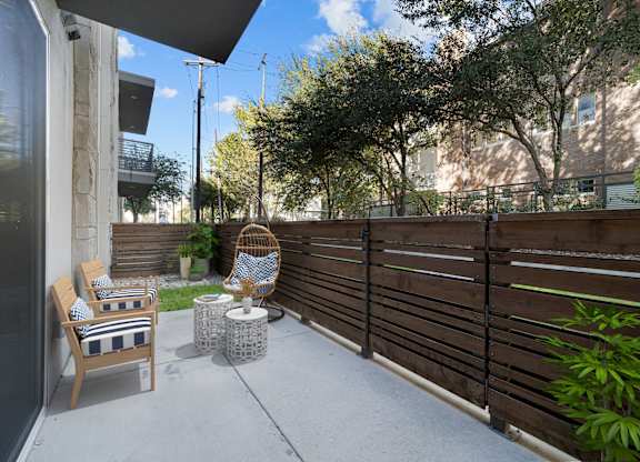 A patio with a chair and table.