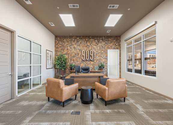 A conference room with a stone wall and a table with chairs.