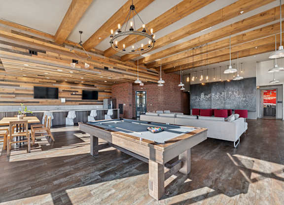 A room with a long wooden table and chairs.