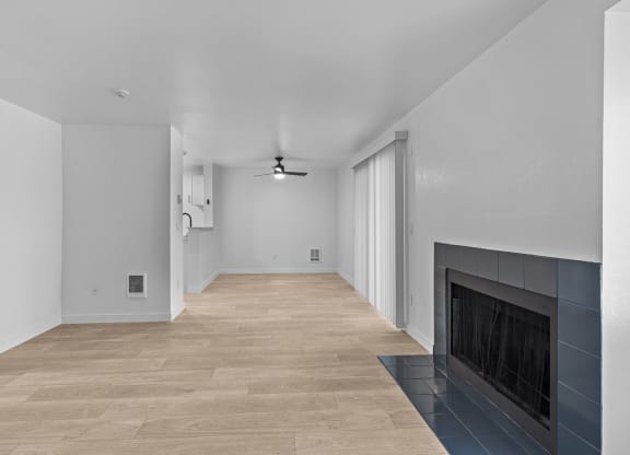 a living room with a fireplace and a wooden floor