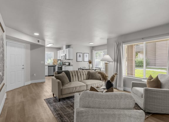 a living room with couches and chairs and a rug