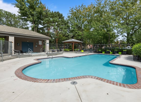 the preserve at ballantyne commons pool and spa with trees and a building