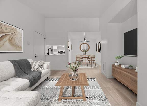 a living room with a white couch and a wooden table