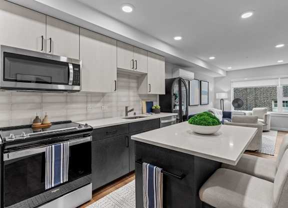 A modern kitchen with a black oven and a white countertop.