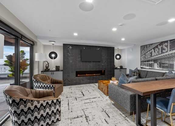 A modern living room with a fireplace and a television.