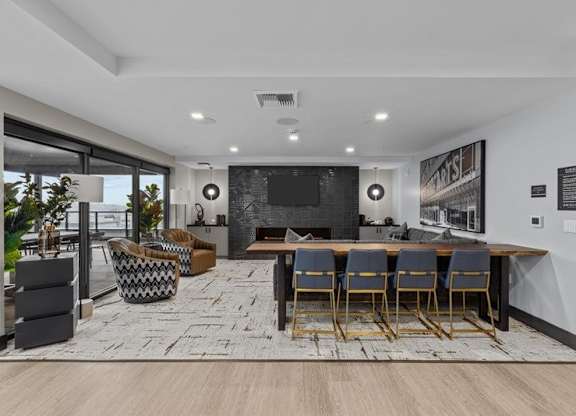 A modern living room with a large TV and comfortable seating.