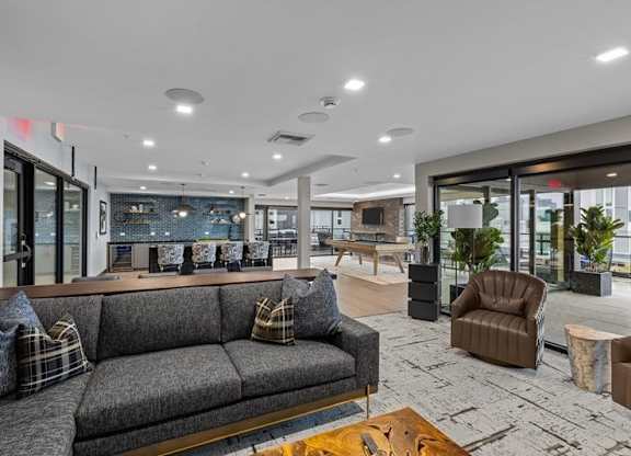 A modern living room with a grey sofa and a coffee table.