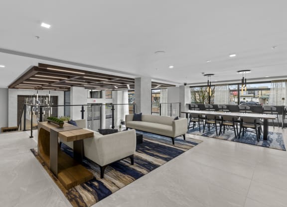 a living room with couches and chairs and a bar with tables and chairs