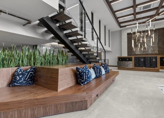 a living room with a wooden bench and a staircase