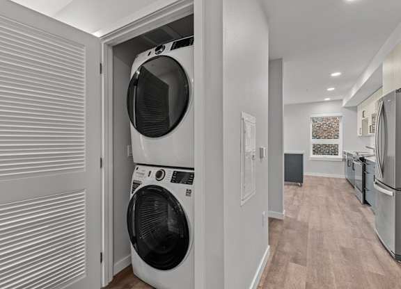A white washing machine is in a small laundry room.