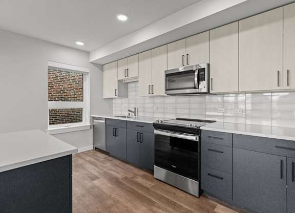 A kitchen with a brick wall in the background.