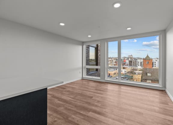 an empty living room with a view of the city
