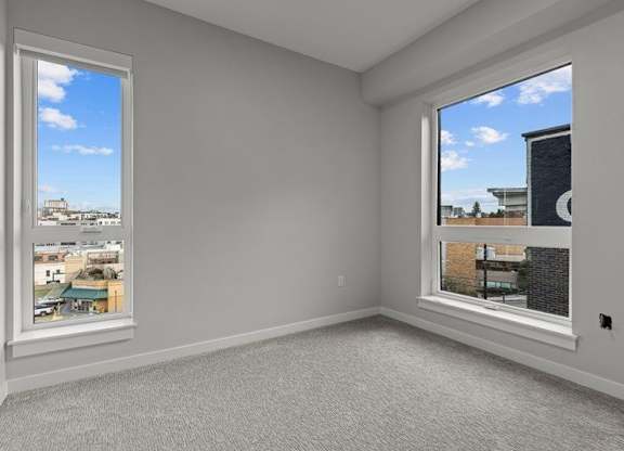A room with a large window overlooking a cityscape.