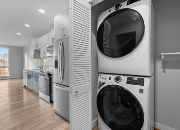 a washer and dryer in a laundry room next to a kitchen