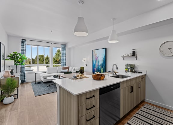 a kitchen with an island and a living room with a clock