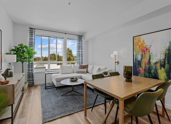 a living room with a couch and a table with chairs