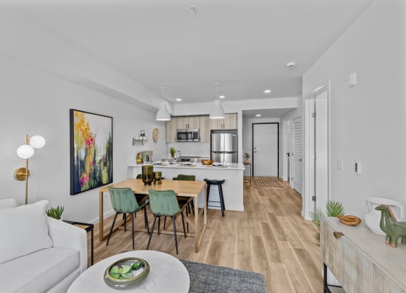 a living room and kitchen with a table and chairs
