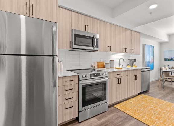 a kitchen with stainless steel appliances and wooden cabinets