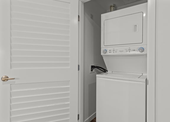 the laundry room has a washer and dryer and a door to the closet